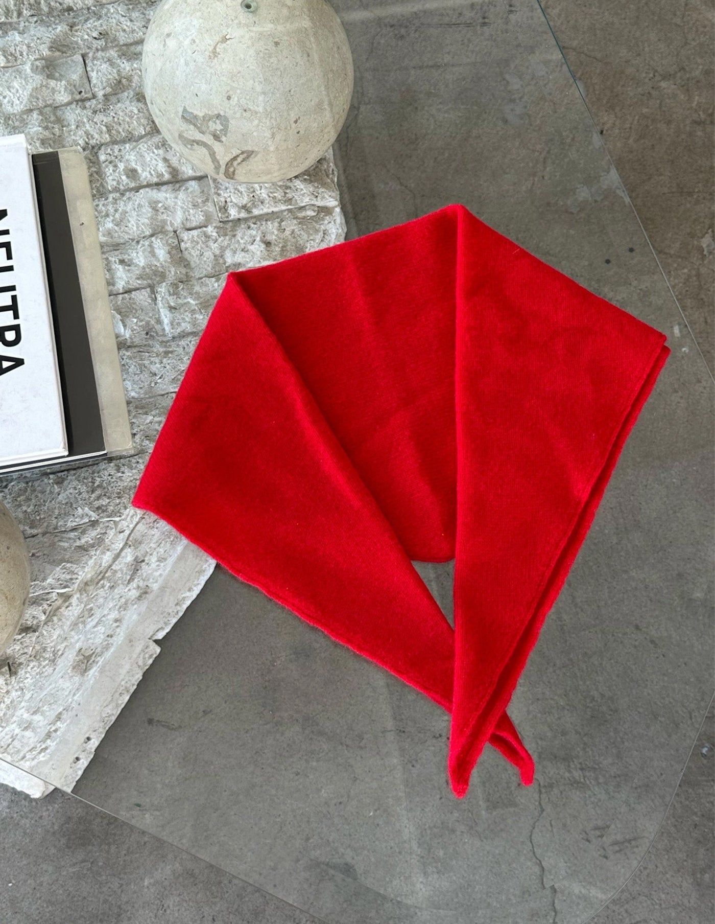 Red fabric on a gray surface with a blurred background