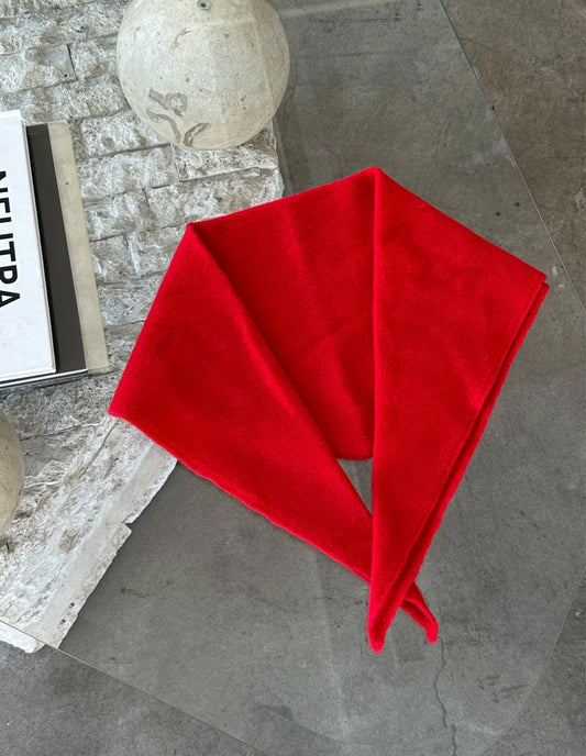 Red fabric on a gray surface with a blurred background