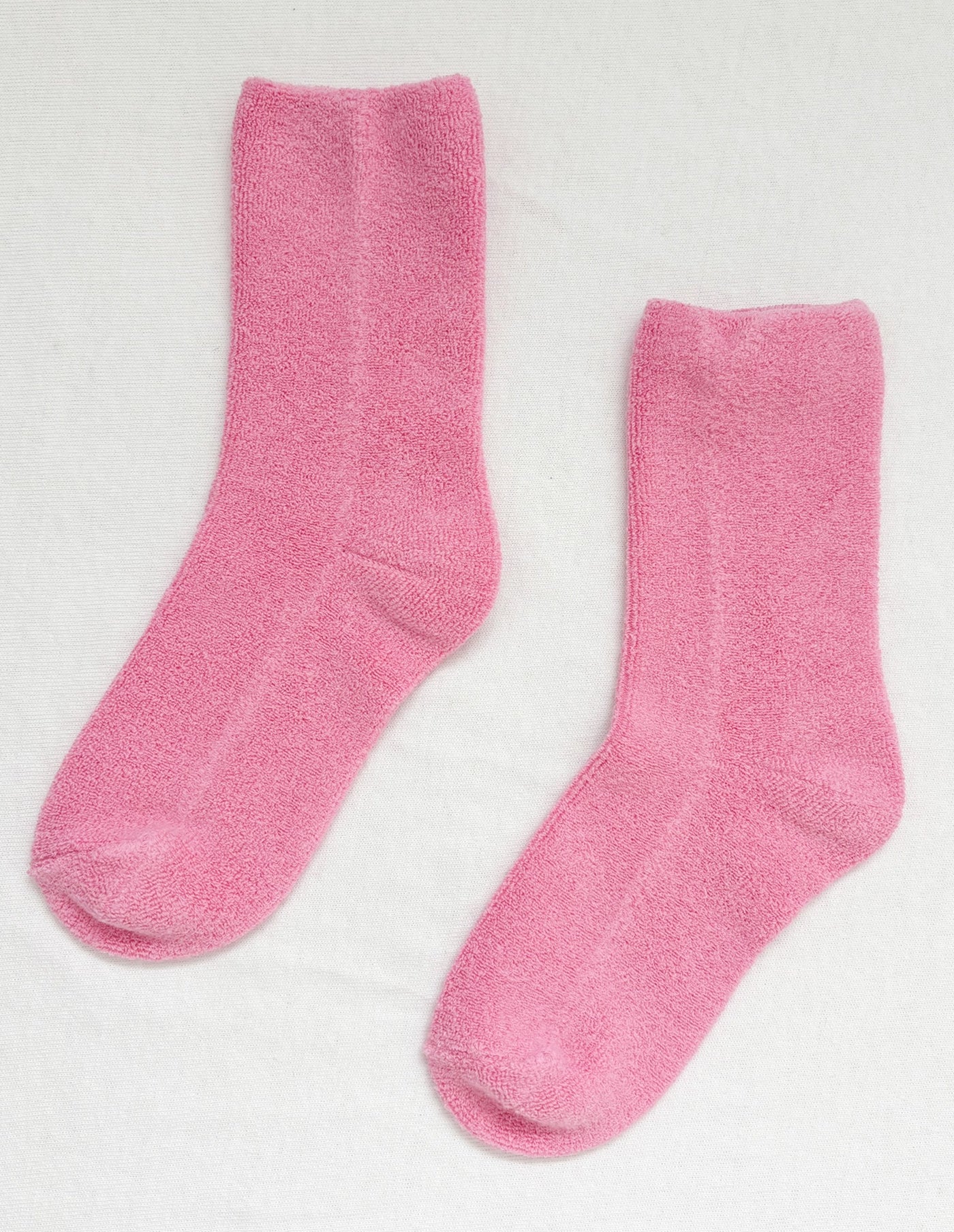 Pair of pink socks on a light gray background