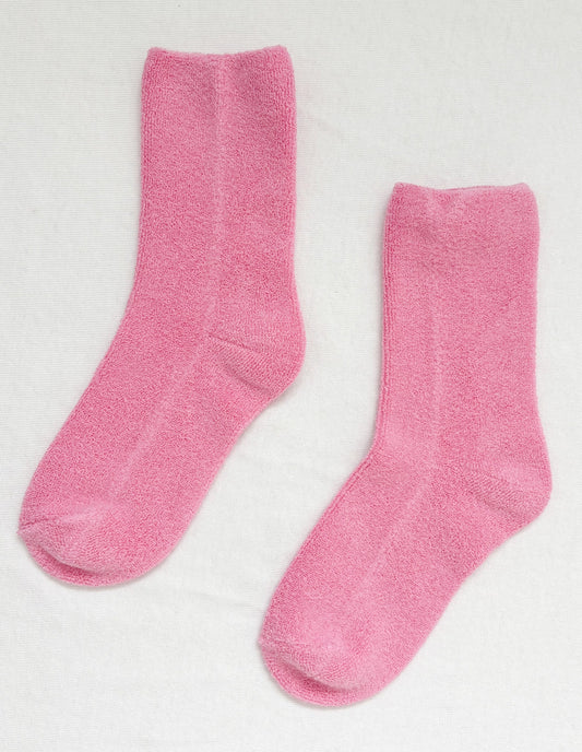 Pair of pink socks on a light gray background