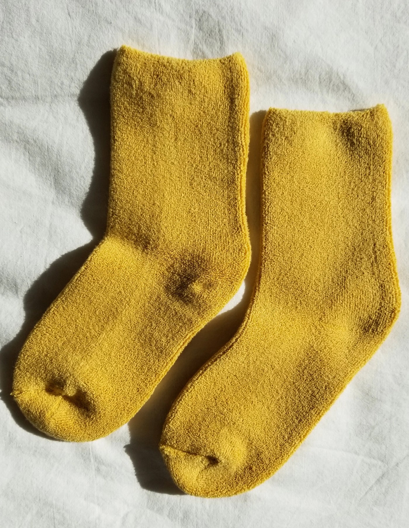 Pair of yellow socks on a white background