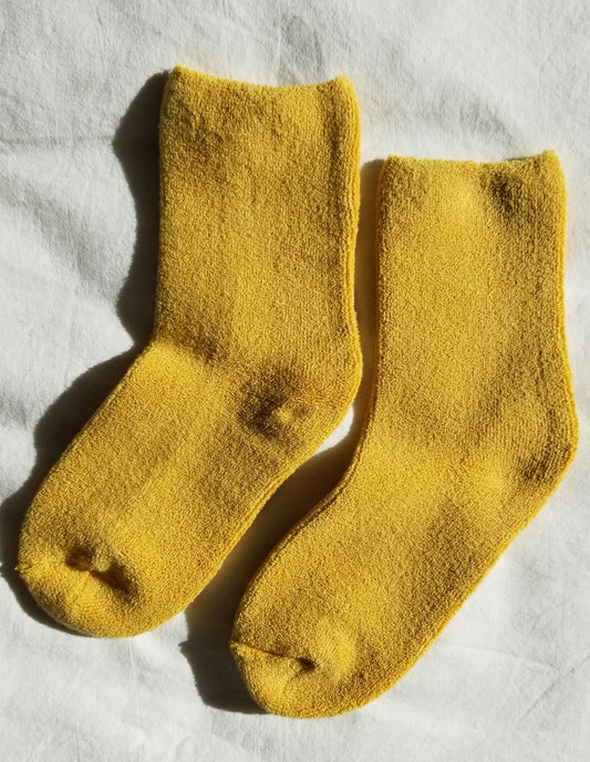 Pair of yellow socks on a white background
