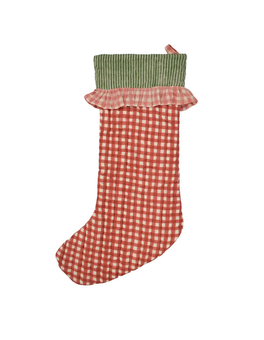 Red and white checkered Christmas stocking with green top on a white background