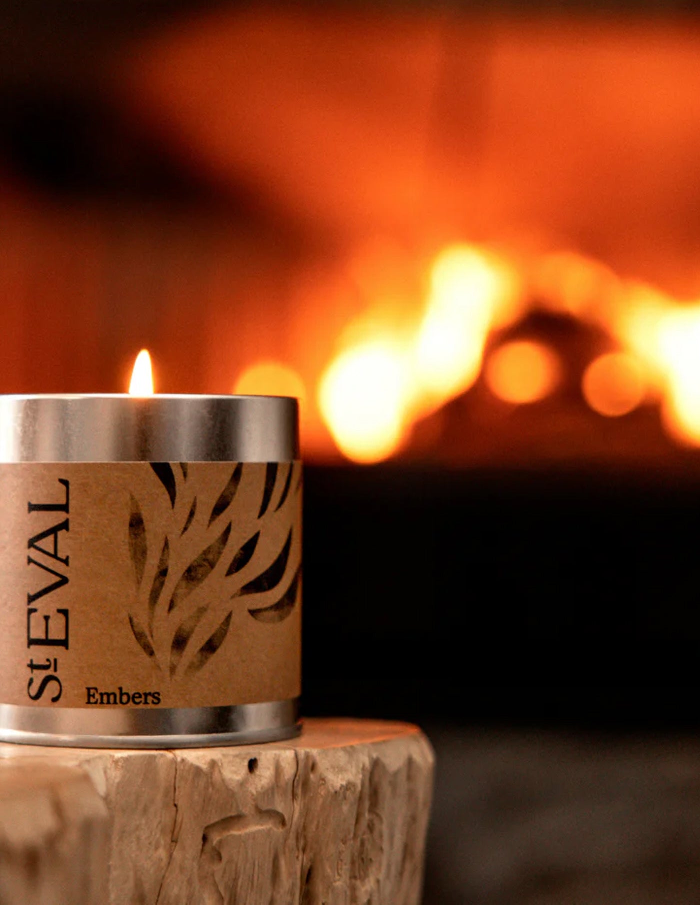 St Eval candle labeled 'Embers' in front of a fireplace