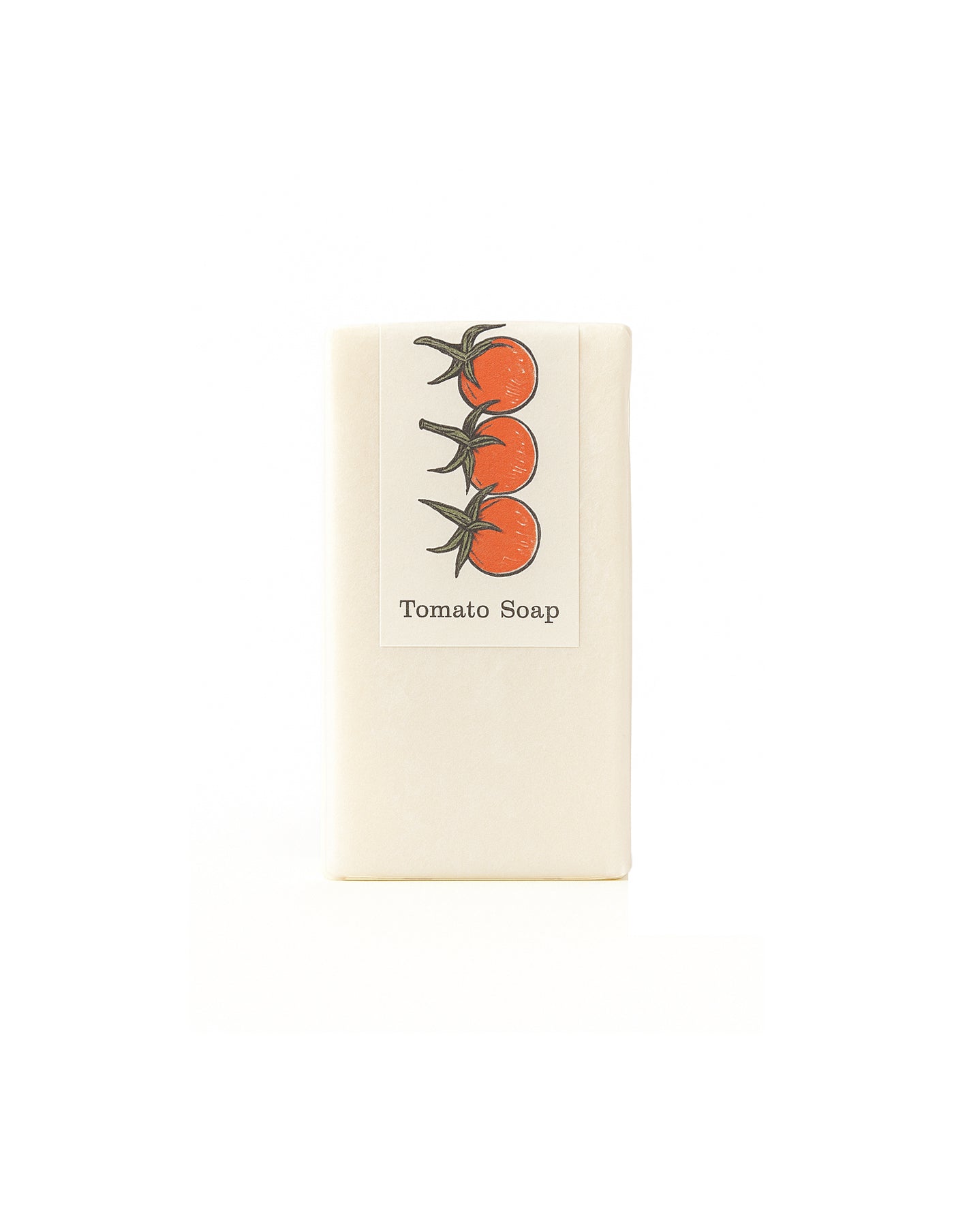 Bar of soap with tomato design and text on a white background