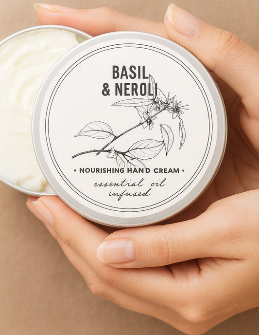 Basil & Neroli hand cream in a tin held by hands against a beige background