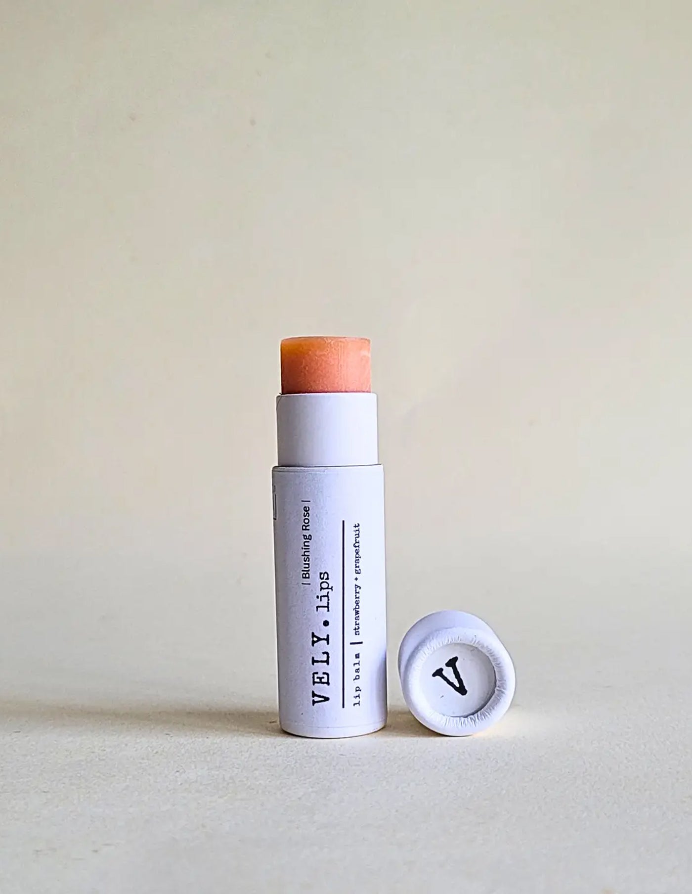 Vely lip balm with cap on a light background