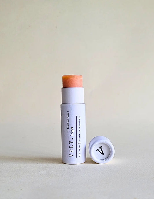 Vely lip balm with cap on a light background