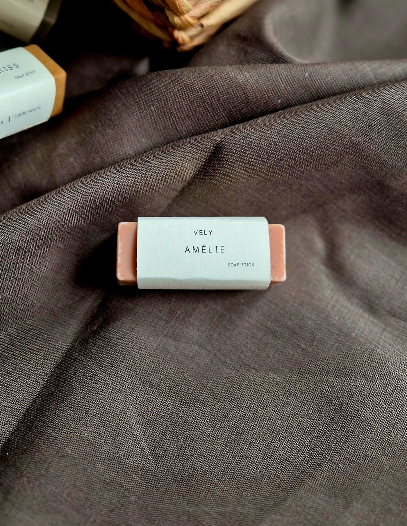 Bar of soap with 'Vely Amelie' label on a textured fabric background
