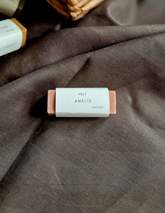Bar of soap with 'Vely Amelie' label on a textured fabric background