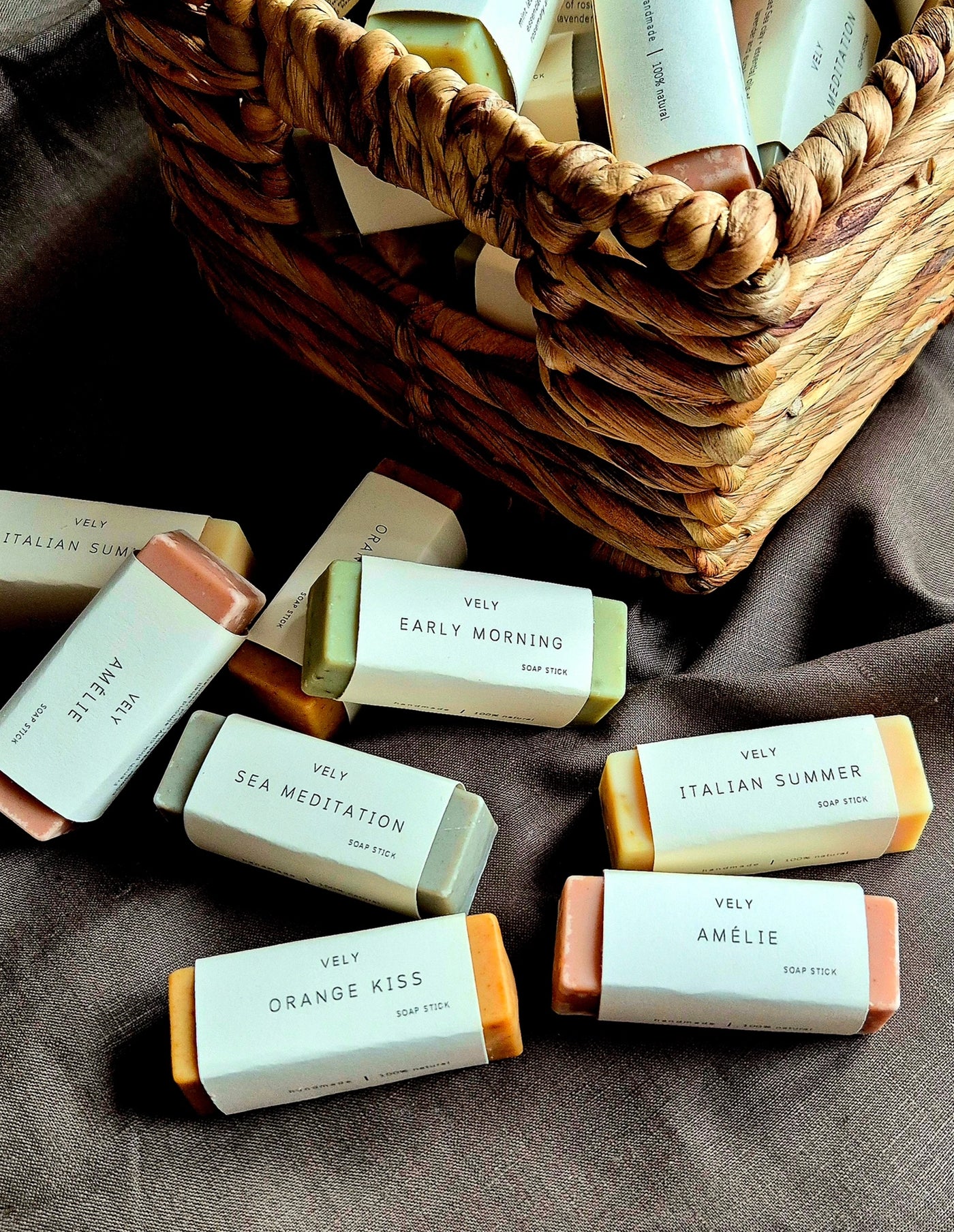 Assorted soaps with visible labels on a textured surface
