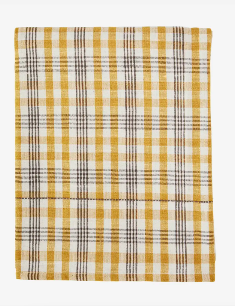 Plaid blanket with yellow and white pattern on a white background